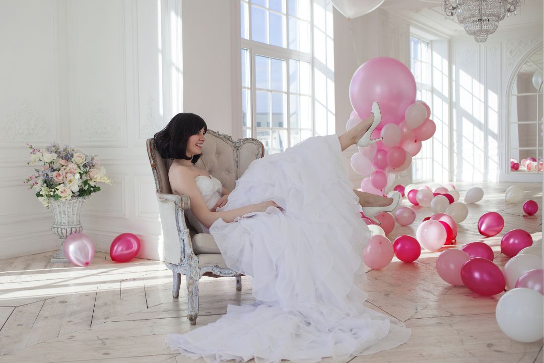 Quinceanera sitting with balloons